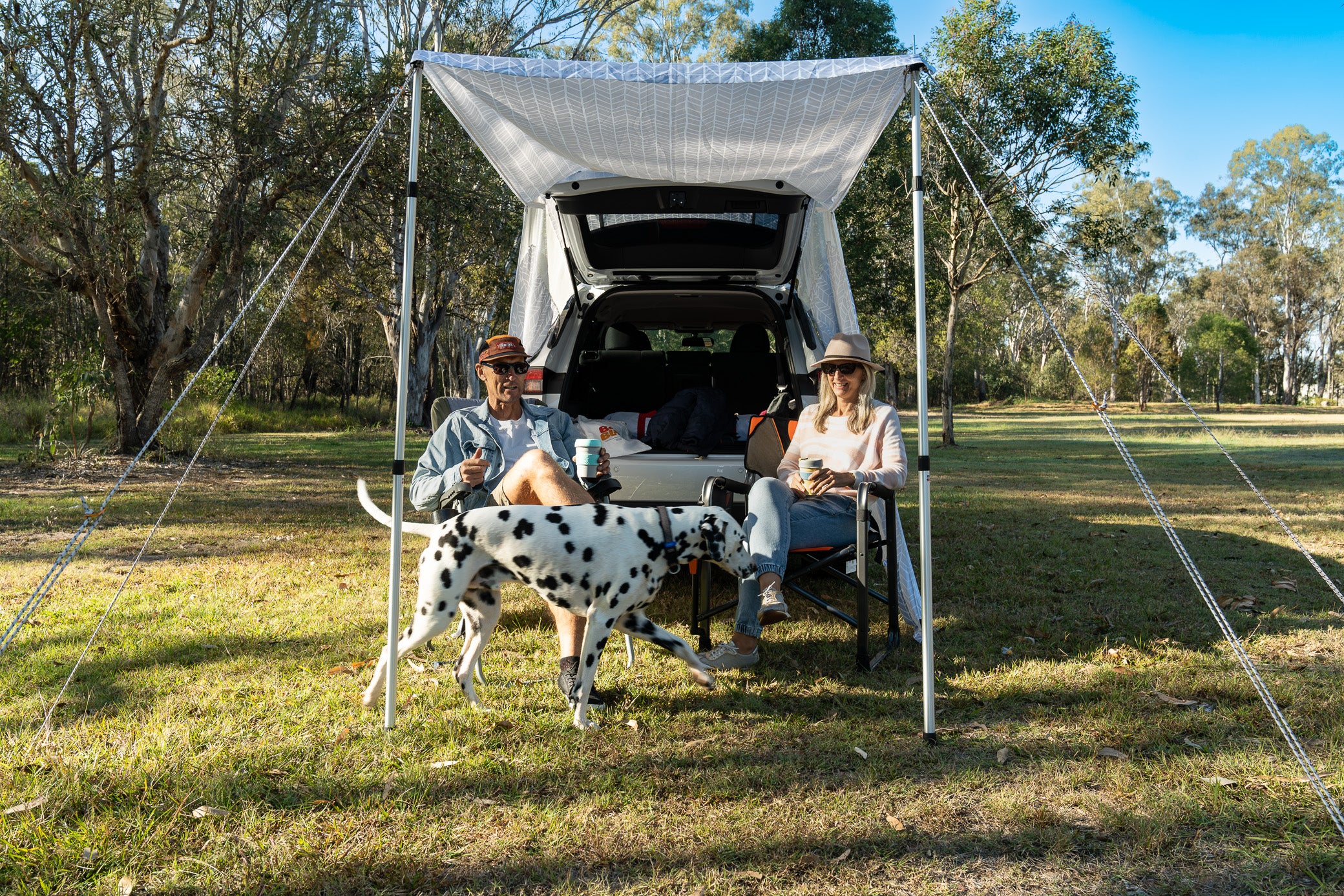 couple having coffee under awning